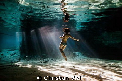   Grand Cenote 374Woman inside Tulum Quintana Roo receiving last rays sun. Inspiring image transmitting awe this magnificent natural wonder produce our souls...its crystal clear freshwater sun souls...it`s soulsit`s souls it`s  